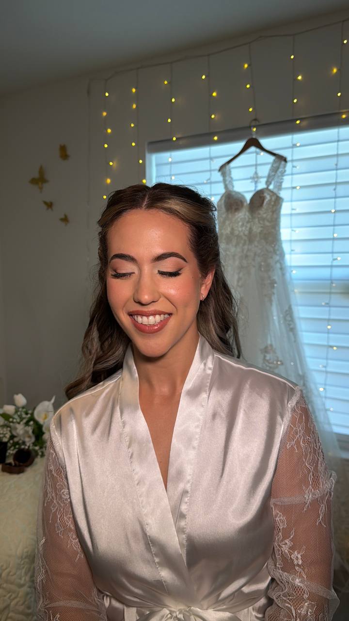 Bride in silk robe with gown and fairy lights