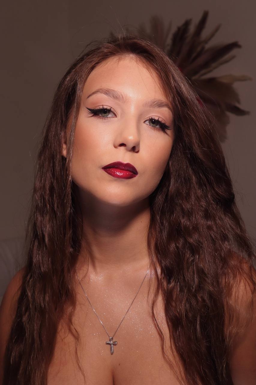 Editorial red lip with feather headpiece